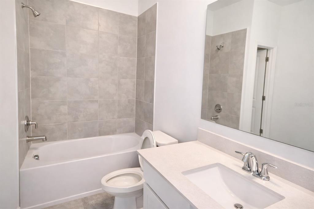 4129 Conjunction Way Apopka, FL 32712 - Photo 6 of 9 a bathroom with a sink a toilet and a bathtub