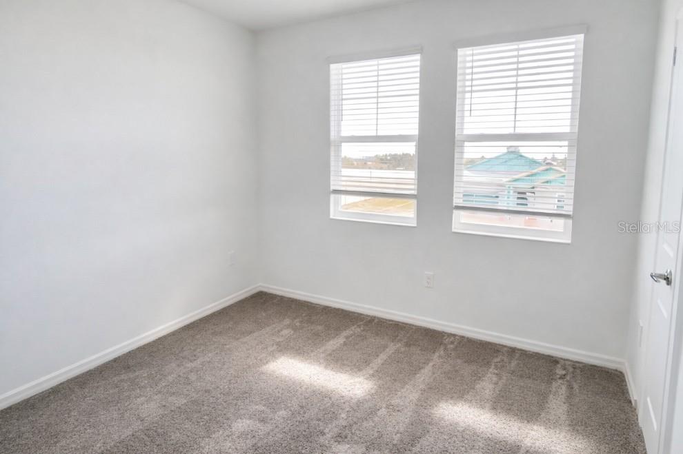 4129 Conjunction Way Apopka, FL 32712 - Photo 7 of 9 an empty room with windows