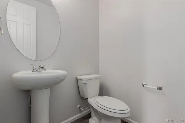 a bathroom with a granite countertop double vanity sink a mirror and shower