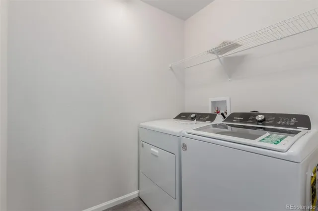 a bathroom with a double vanity sink a toilet and a bathtub