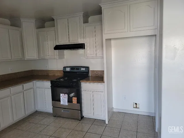 a kitchen with white cabinets