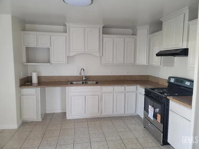 a kitchen with cabinets appliances and a sink
