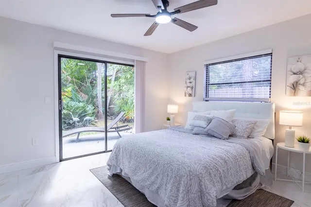 a bedroom with a large bed and a large window