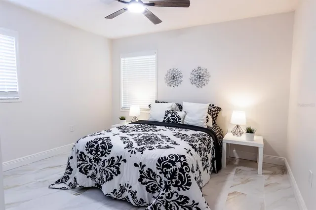 a bedroom with a bed and a chair