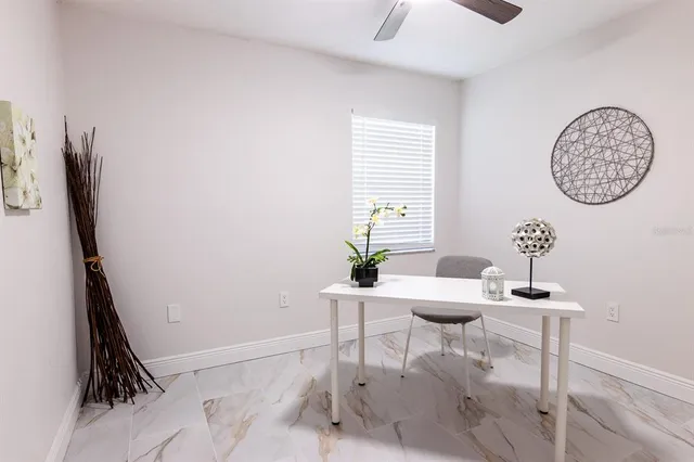 a view of a room with a table and chairs