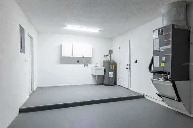 a view of a kitchen with refrigerator and workspace