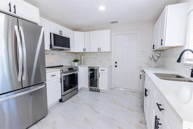 a kitchen with a sink stove and refrigerator