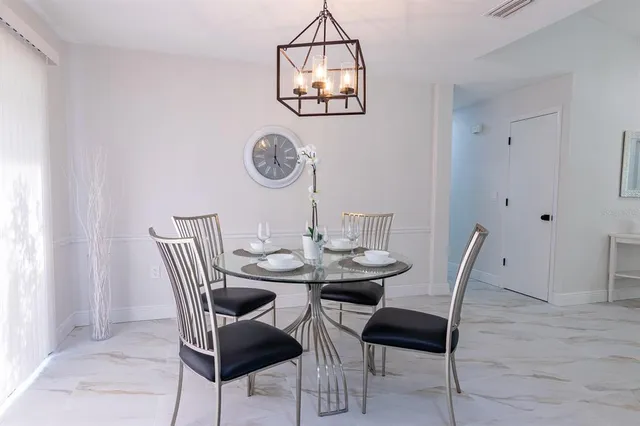 a view of a dining room with furniture and a table