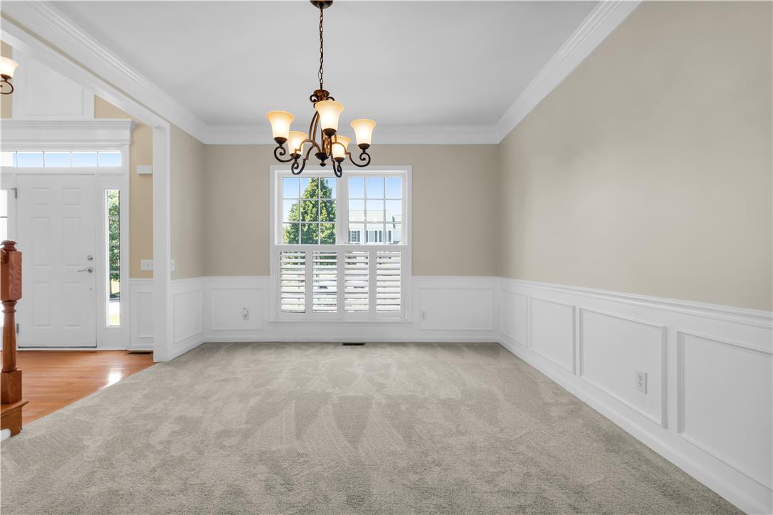 1709 Travers Road Breinigsville, PA 18031 - Photo 19 of 55 A classic dining area with wainscoting and a beautiful chandelier, perfect for memorable meals.
