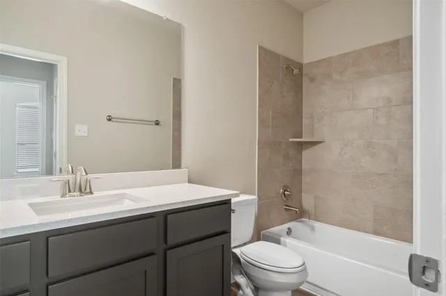 a bathroom with a sink toilet tub and shower