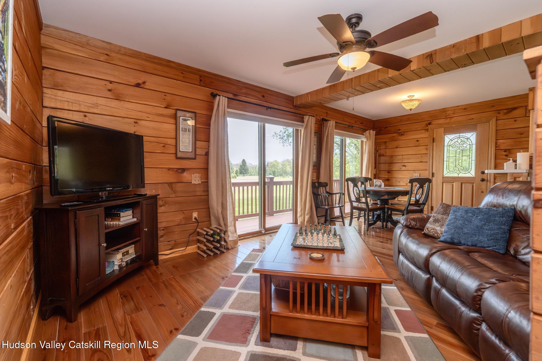 140 Stone Dock Road High Falls, NY 12440 - Photo 6 of 42 a living room with furniture a flat screen tv and kitchen view