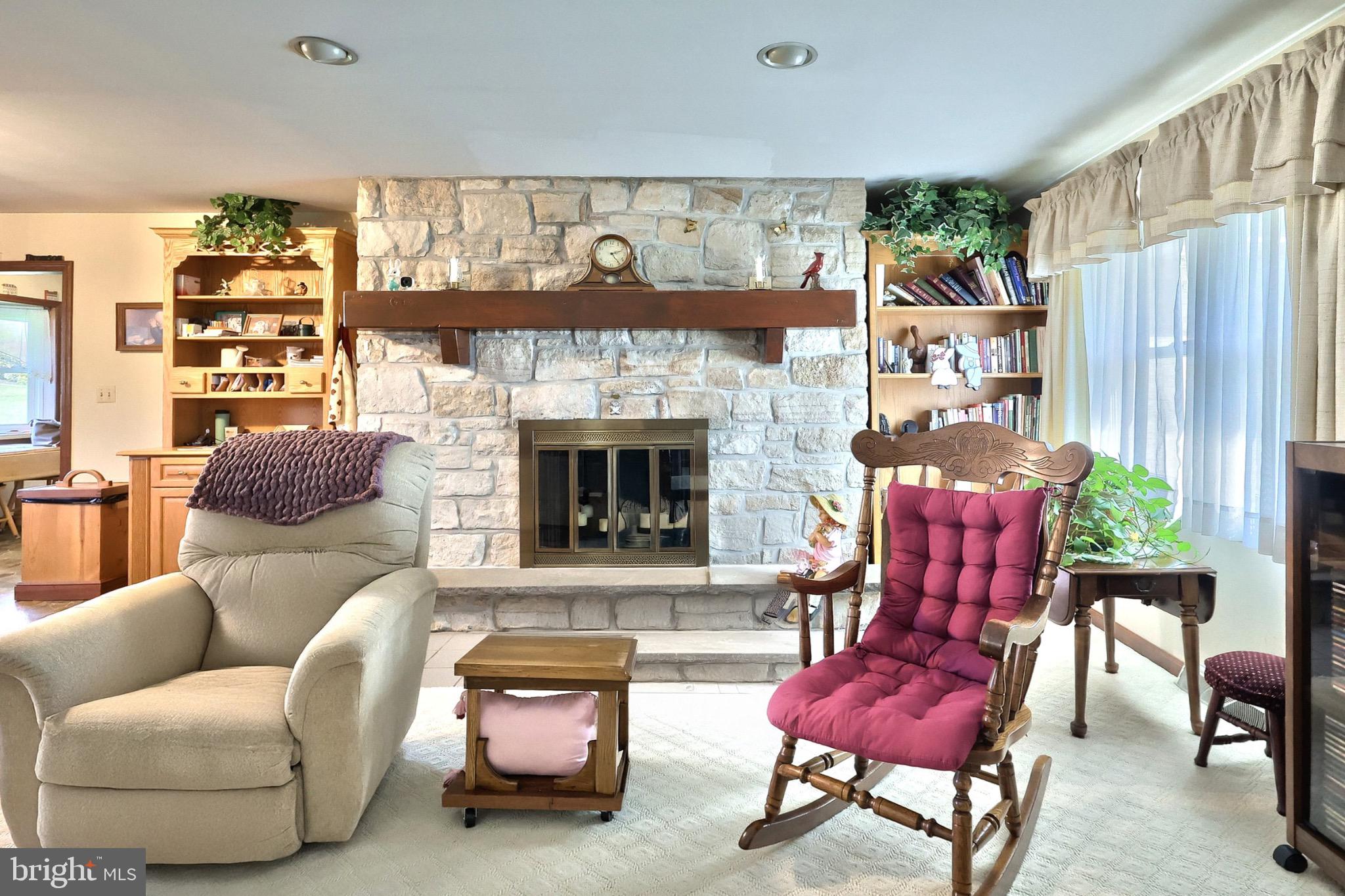 244 Miller Road Akron, PA 17501 - Photo 11 of 34 Cozy living space with stone fireplace charm.