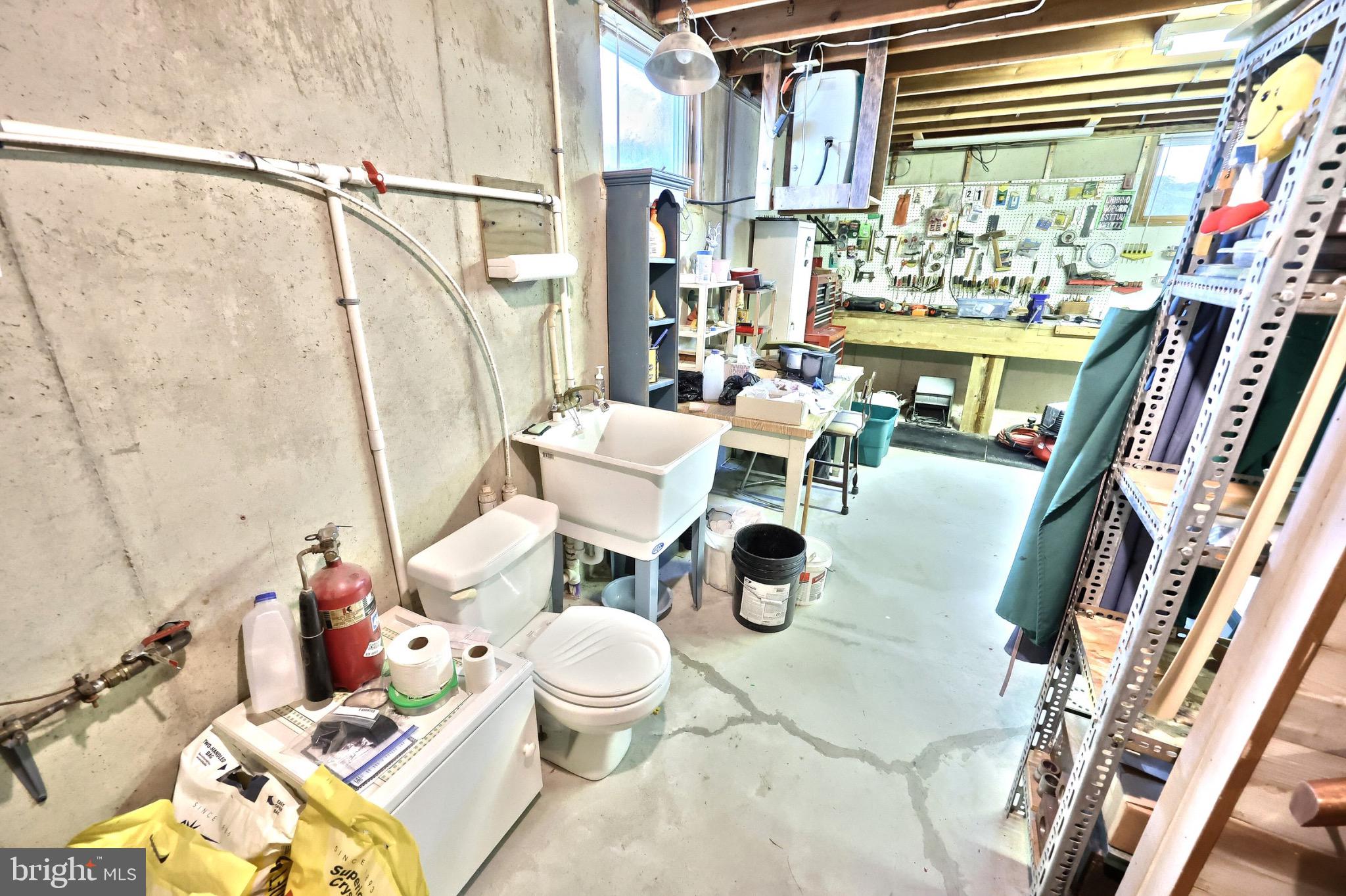 244 Miller Road Akron, PA 17501 - Photo 24 of 34 Functional basement workspace with ample storage.