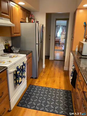 a kitchen with stainless steel appliances granite countertop a refrigerator and a stove