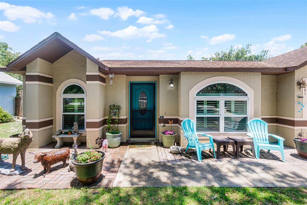 a front view of a house with outdoor seating