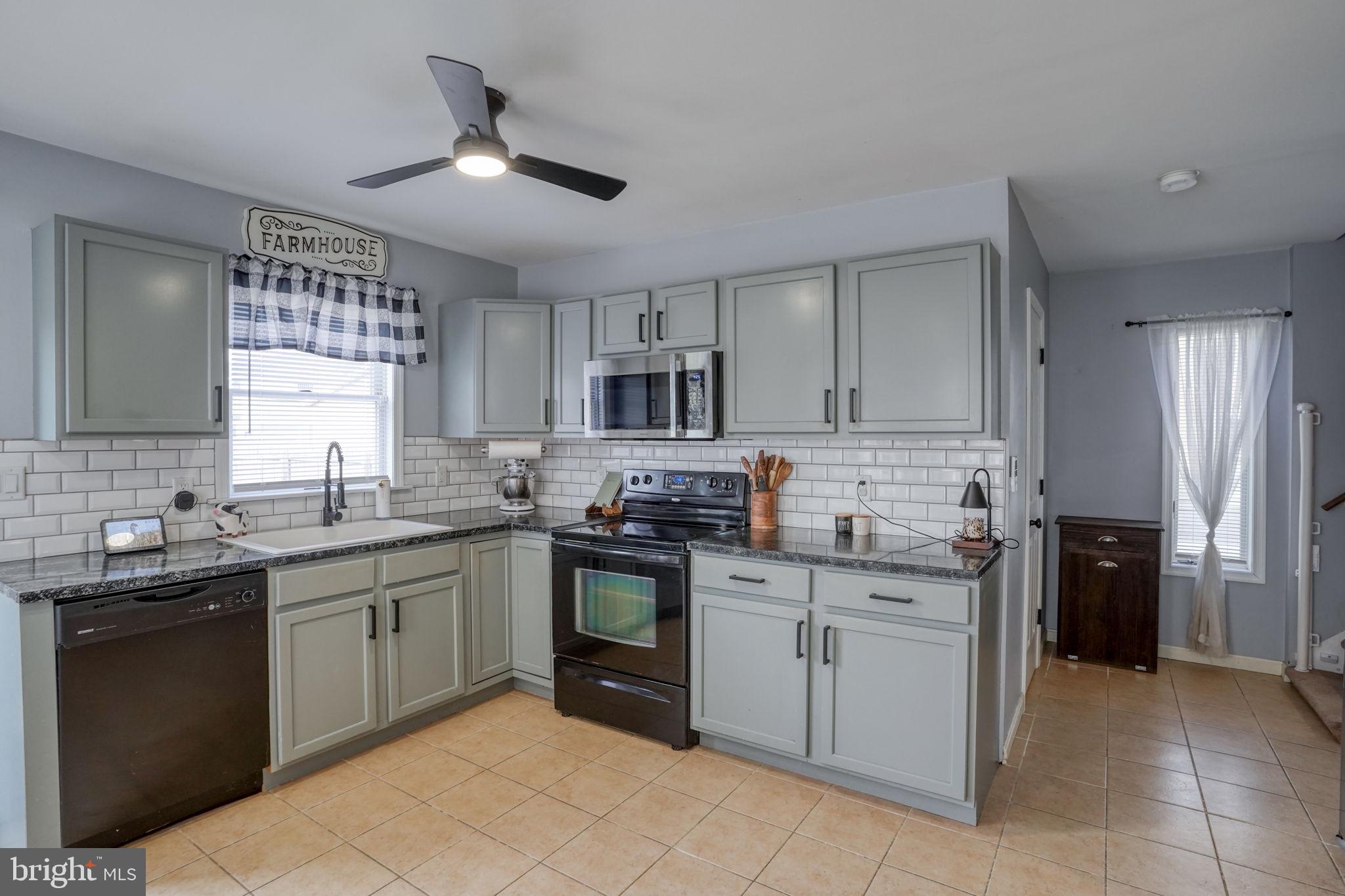 31 Washington Street Dover, DE 19901 - Photo 23 of 38 a kitchen with a sink stove and cabinets