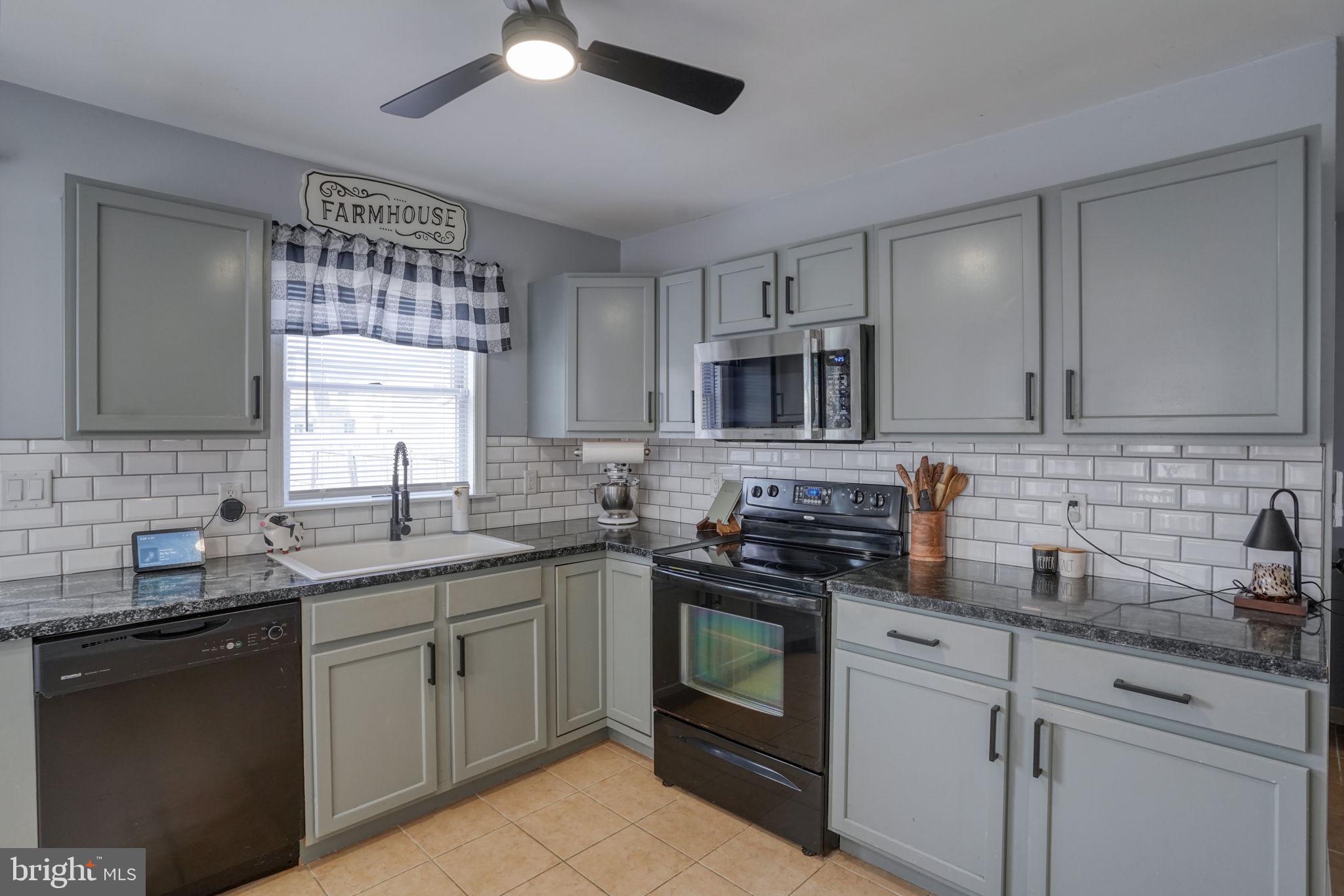 31 Washington Street Dover, DE 19901 - Photo 24 of 38 a kitchen with stainless steel appliances granite countertop a sink stove and cabinets