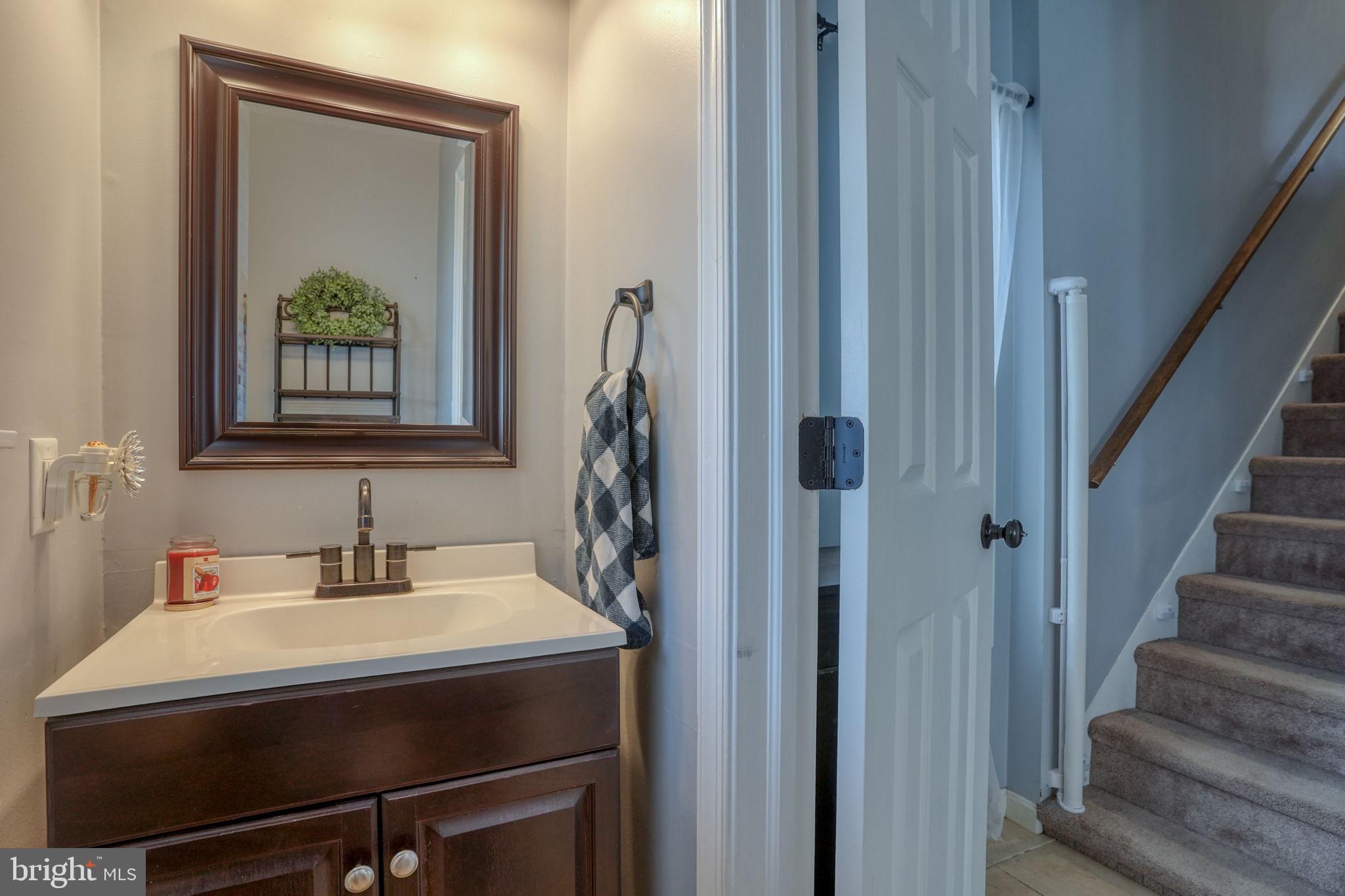 31 Washington Street Dover, DE 19901 - Photo 25 of 38 a bathroom with a sink and a mirror