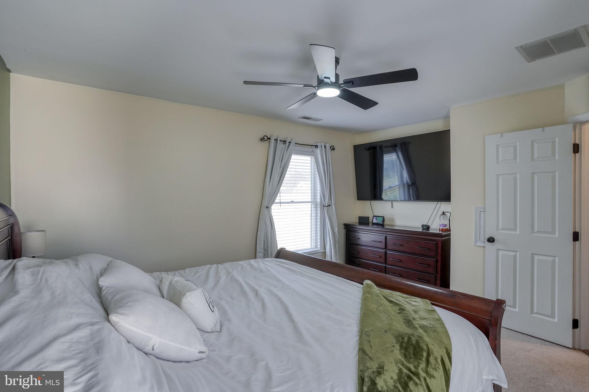 31 Washington Street Dover, DE 19901 - Photo 33 of 38 a bedroom with a bed and a chandelier
