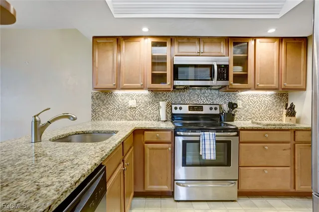 a kitchen with stainless steel appliances granite countertop a stove and a sink