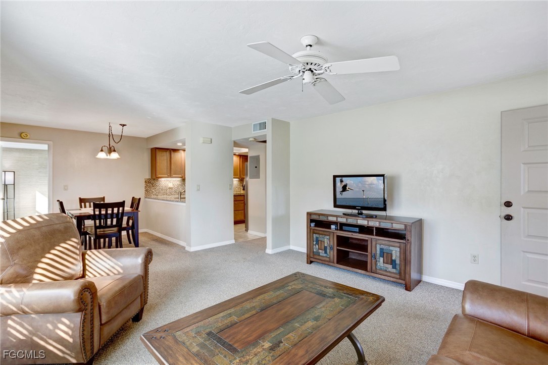 13256 Whitehaven Lane, Unit 501 Fort Myers, FL 33966 - Photo 8 of 28 a living room with furniture and a flat screen tv