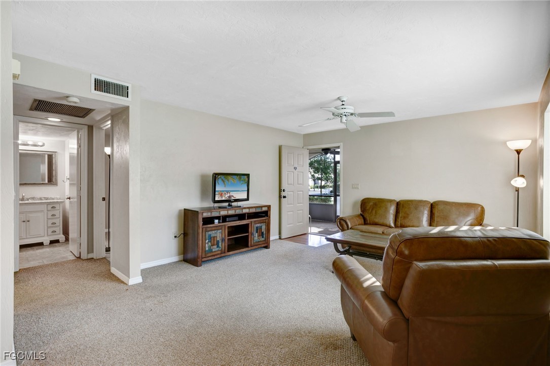 13256 Whitehaven Lane, Unit 501 Fort Myers, FL 33966 - Photo 9 of 28 a living room with furniture and a flat screen tv