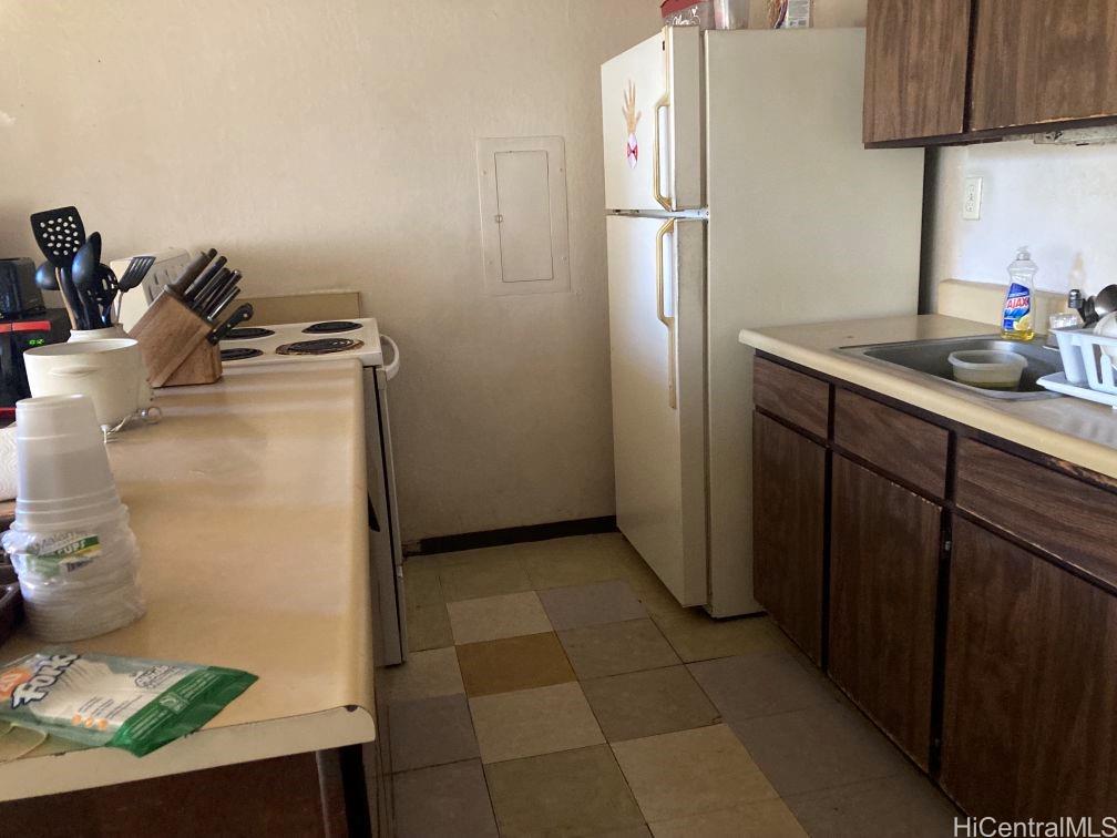 84-757 Kiana Place, Unit 724B Waianae, HI 96792 - Photo 3 of 11 a kitchen with a refrigerator and cabinets