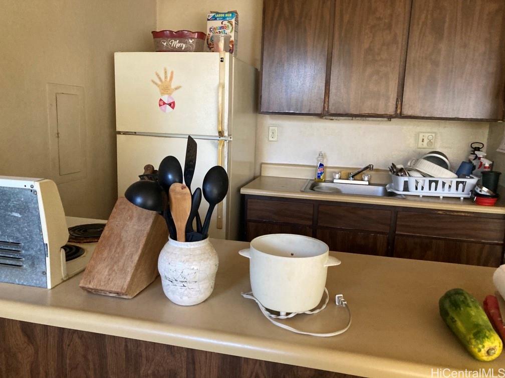 84-757 Kiana Place, Unit 724B Waianae, HI 96792 - Photo 4 of 11 a kitchen with a sink and a stove