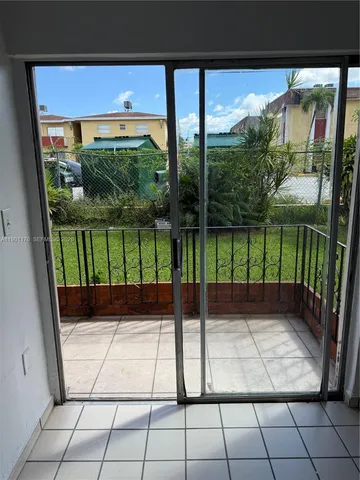 a view of a floor to ceiling window next to a yard