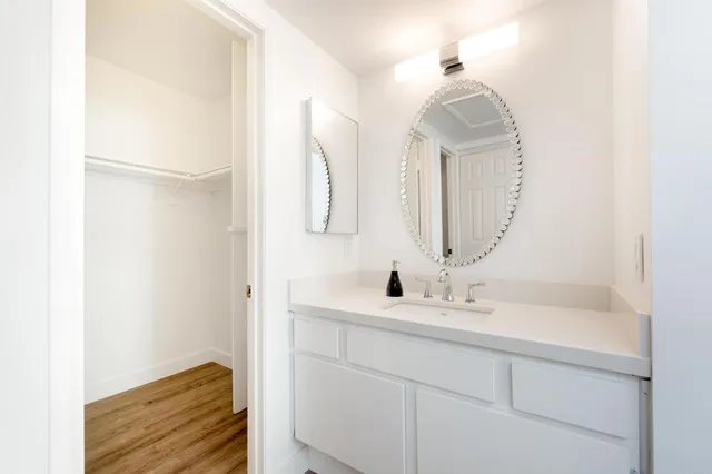 a bedroom with a bed a table and chair