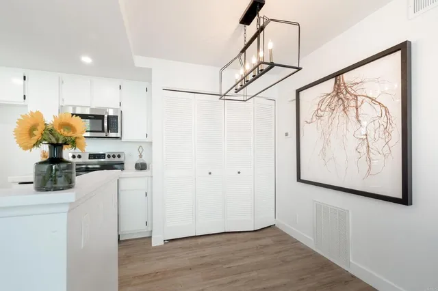 a kitchen with stainless steel appliances a refrigerator and a refrigerator