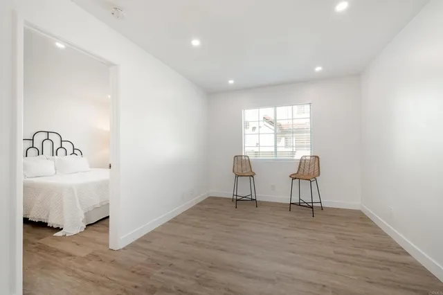 a view of a room with wooden floor and windows