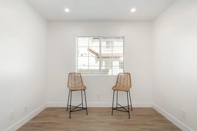 a room with wooden floor and windows