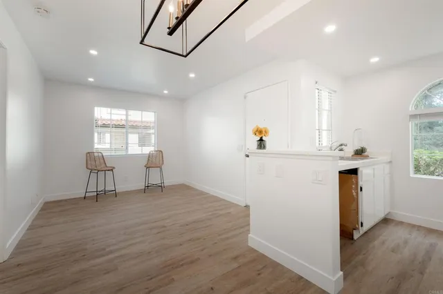 a view of kitchen and hall with wooden floor