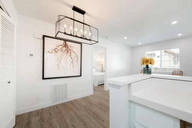 a view of a kitchen with wooden floor and a window