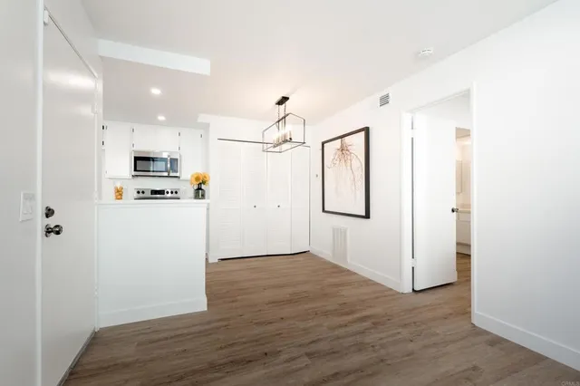 a view of a kitchen with wooden floor and a window