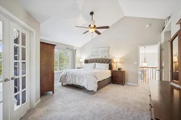 a bed room with a bed and a ceiling fan