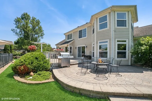 a view of a house with backyard sitting area and garden