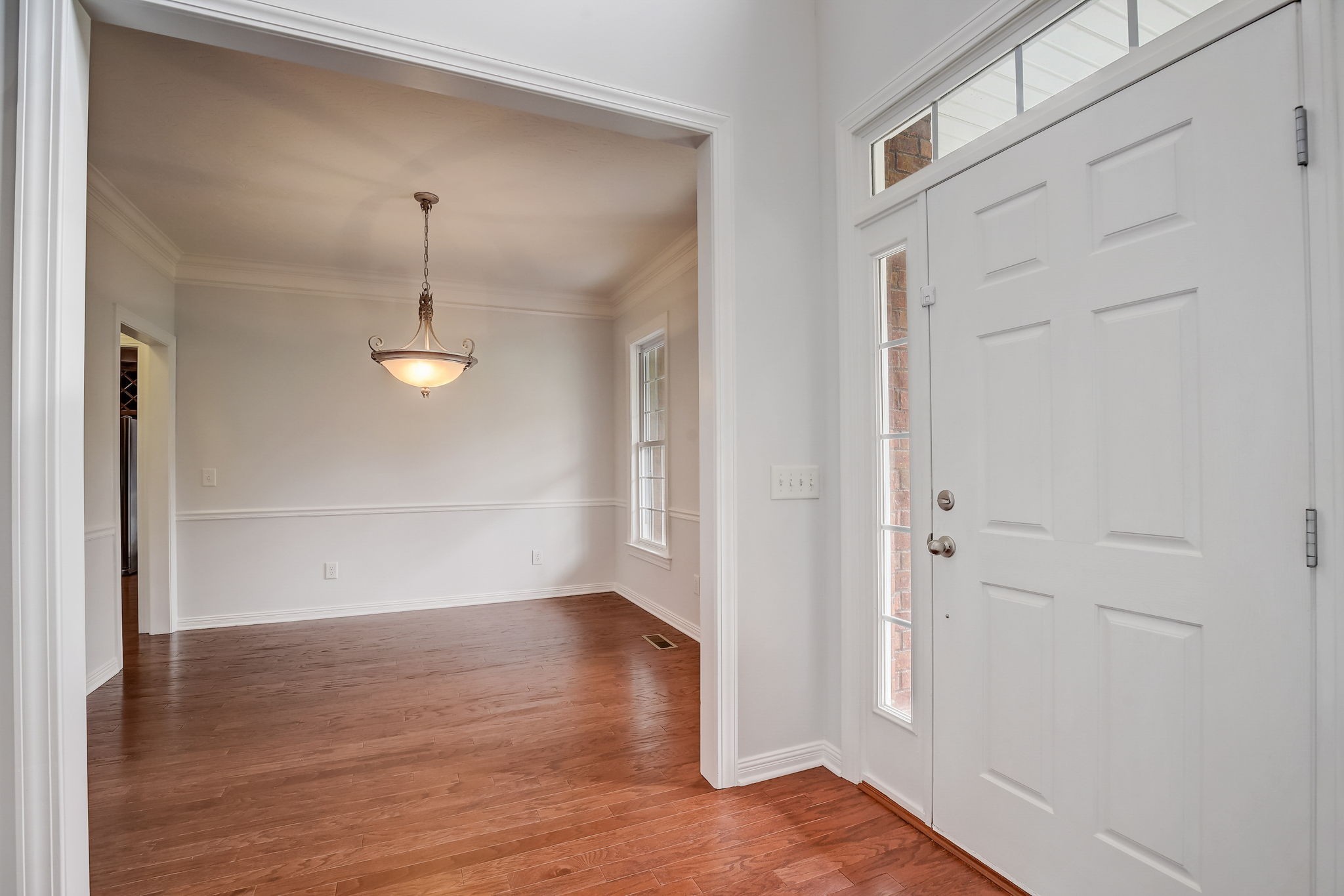 124 Cedar Ridge Lane Hendersonville, TN 37075 - Photo 11 of 66 an empty room with wooden floor mirror and windows