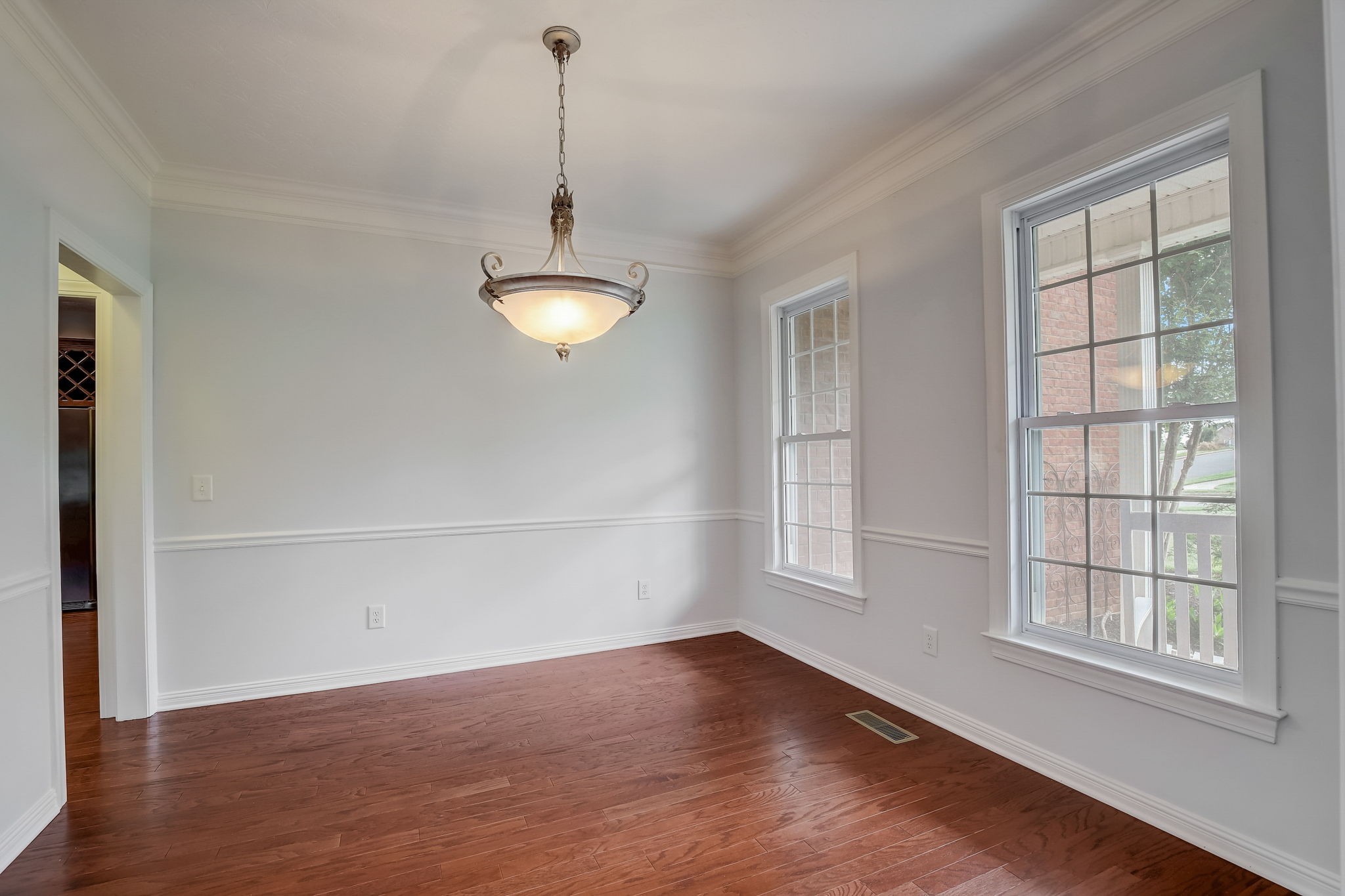 124 Cedar Ridge Lane Hendersonville, TN 37075 - Photo 12 of 66 an empty room with wooden floor exposed radiator and windows