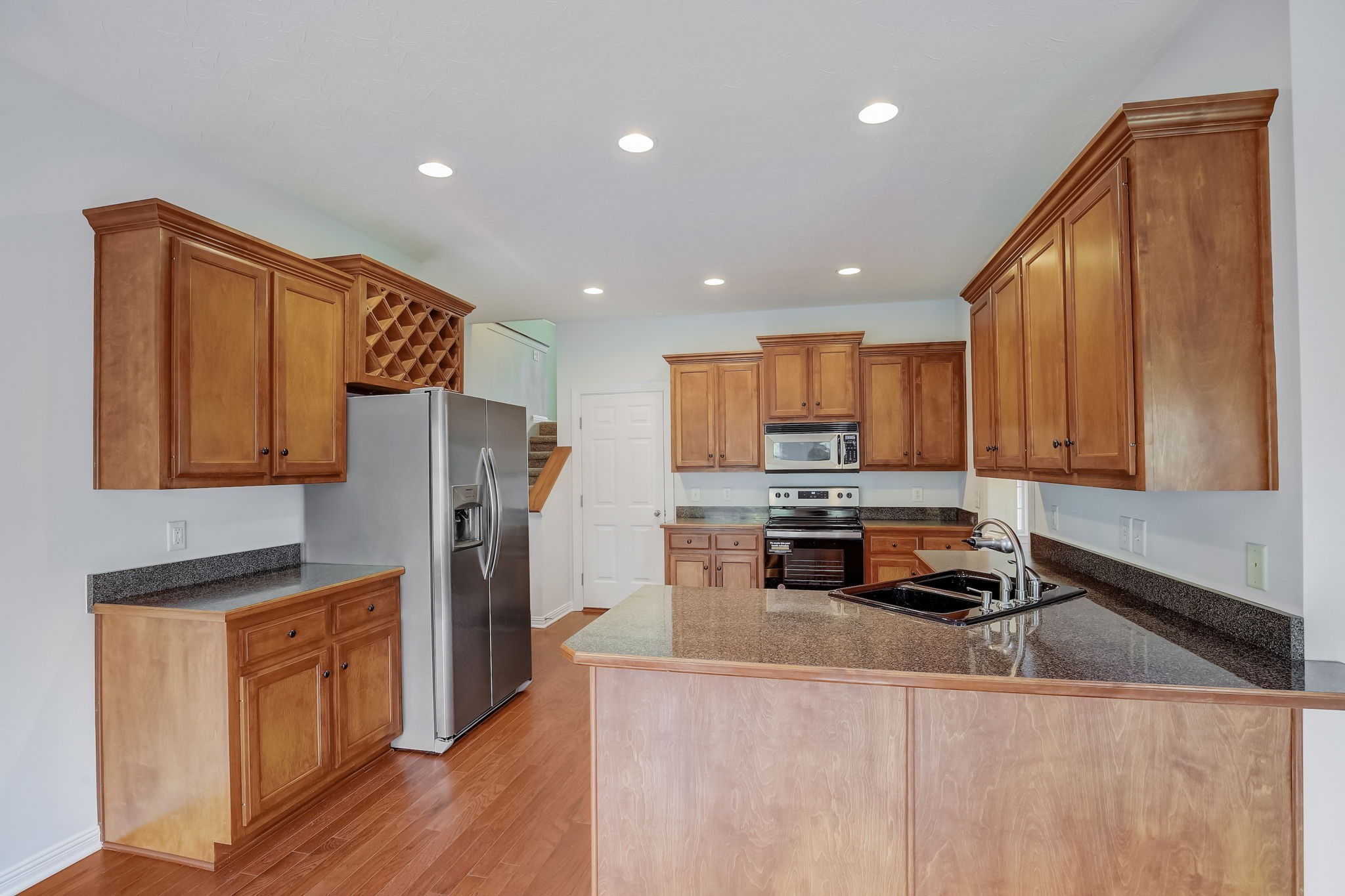 124 Cedar Ridge Lane Hendersonville, TN 37075 - Photo 22 of 66 a kitchen with stainless steel appliances granite countertop a refrigerator a stove top oven a sink and dishwasher