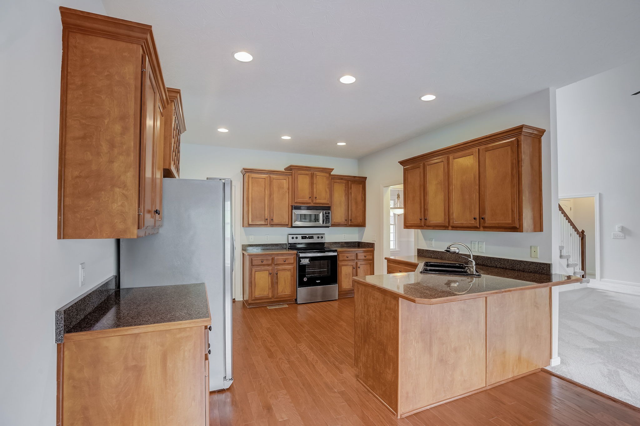 124 Cedar Ridge Lane Hendersonville, TN 37075 - Photo 23 of 66 a kitchen with stainless steel appliances granite countertop a stove a sink a refrigerator and a microwave