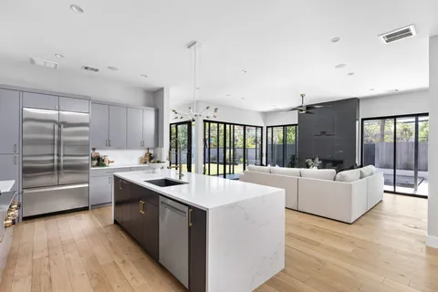 a large white kitchen with a large window