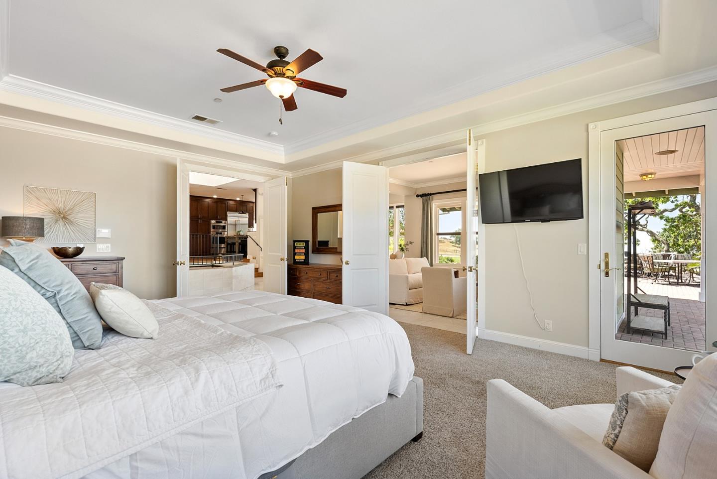 4460 Roop Road Gilroy, CA 95020 - Photo 23 of 68 a spacious bedroom with a large bed a flat screen tv and a couch