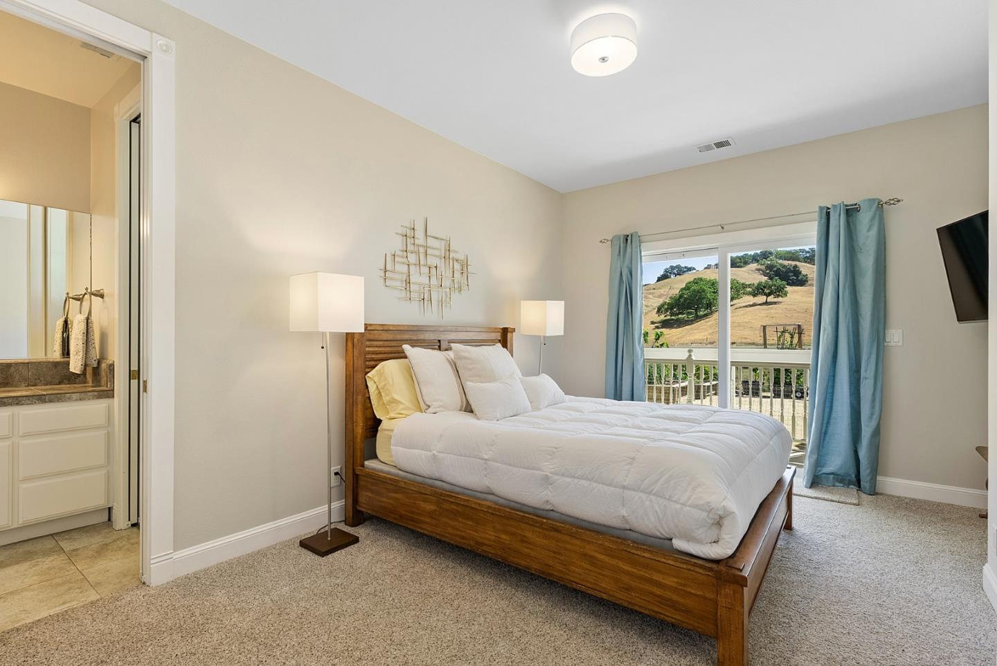 4460 Roop Road Gilroy, CA 95020 - Photo 28 of 68 a bedroom with a bed and large windows