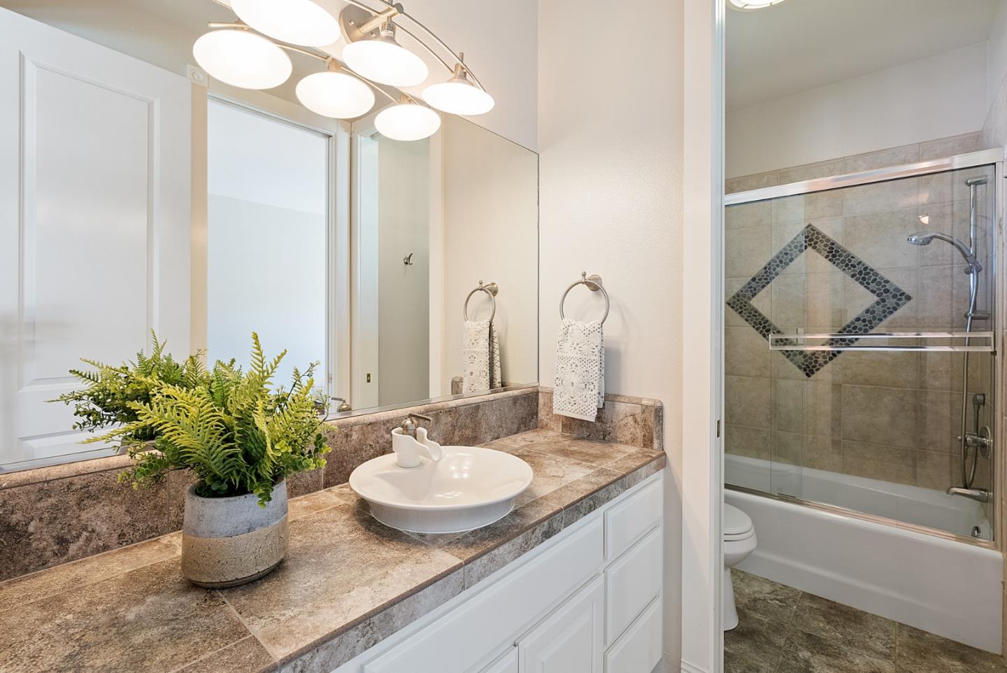 4460 Roop Road Gilroy, CA 95020 - Photo 29 of 68 a bathroom with a granite countertop sink and a mirror
