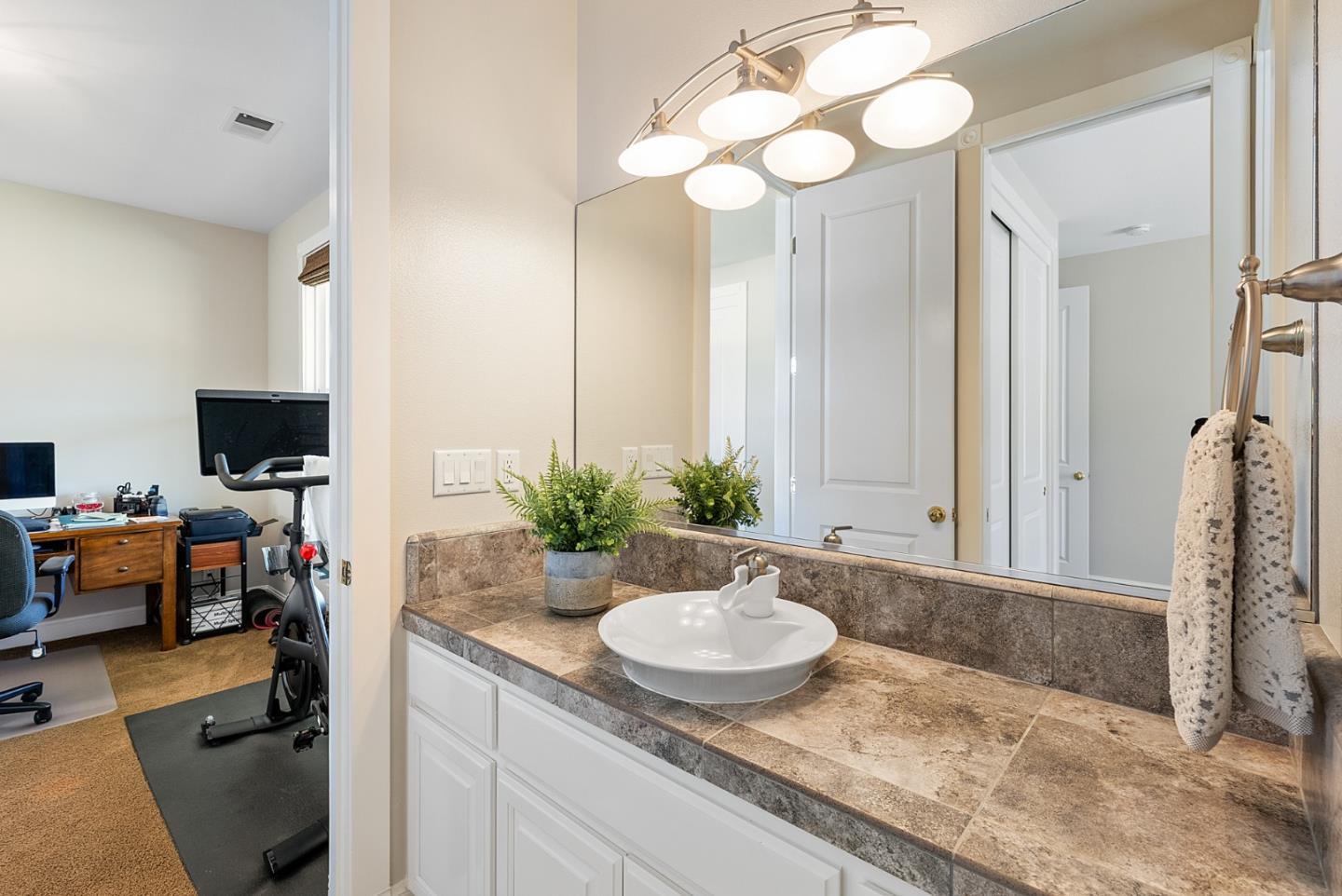 4460 Roop Road Gilroy, CA 95020 - Photo 30 of 68 a bathroom with a granite countertop sink and a mirror