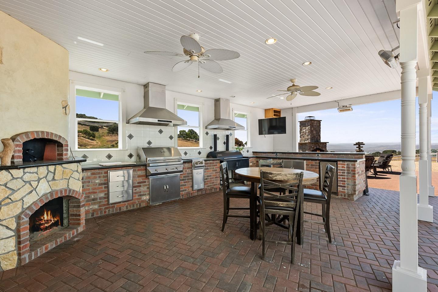 4460 Roop Road Gilroy, CA 95020 - Photo 34 of 68 a kitchen with stainless steel appliances kitchen island granite countertop a stove a sink a dining table and chairs