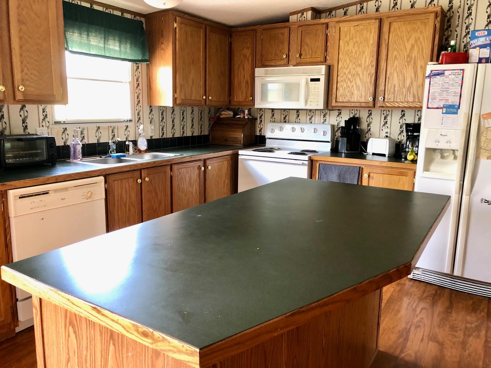 136 Mountain Road Blaine, TN 37709 - Photo 17 of 21 a view of a kitchen with kitchen island a large window a sink and a counter space