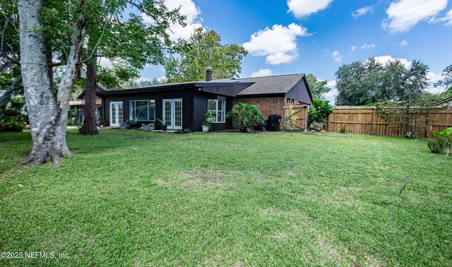 a view of a livingroom with a window and wooden floor